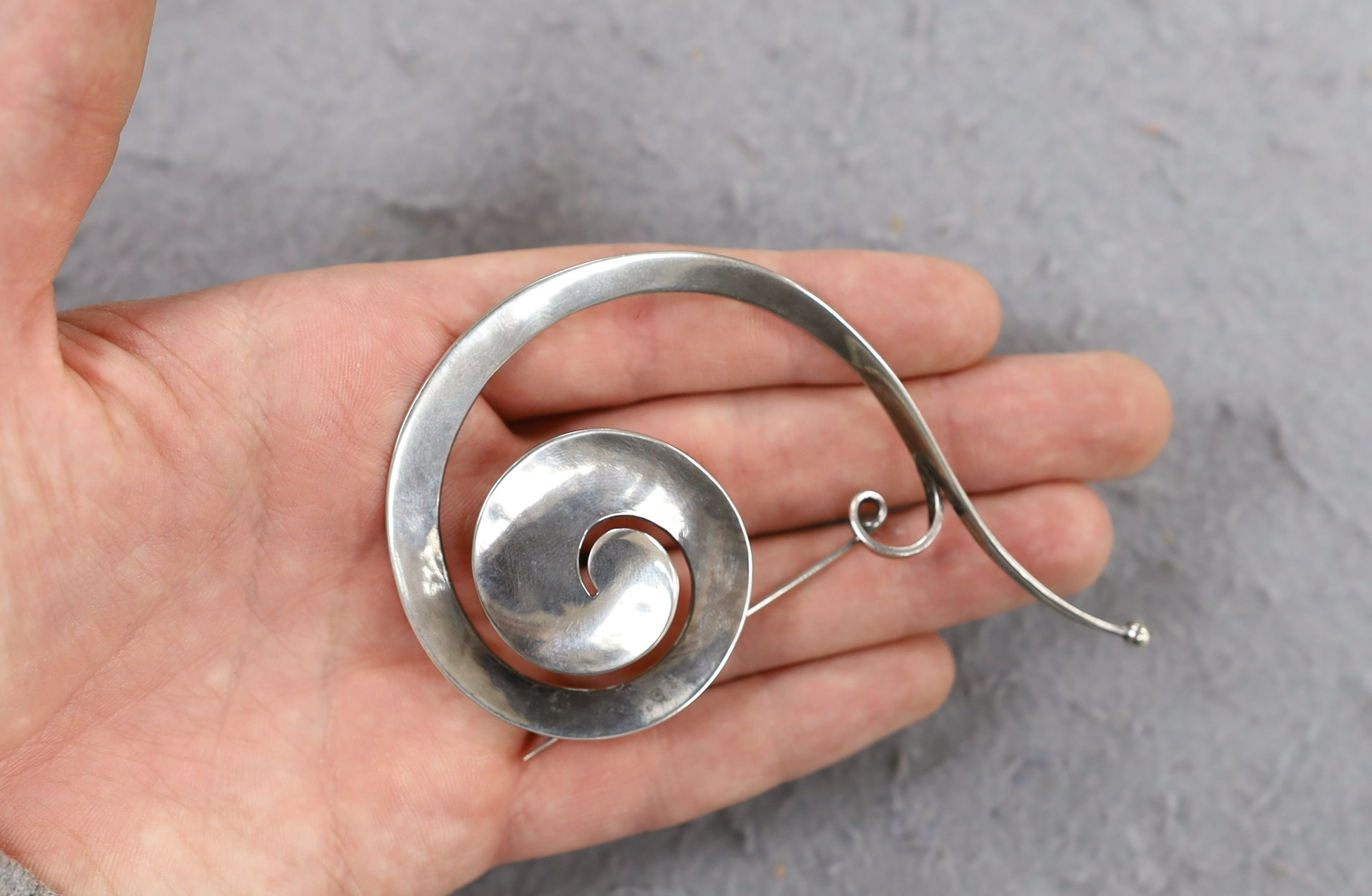 A Vivianna Torun for Georg Jensen sterling silver scroll brooch